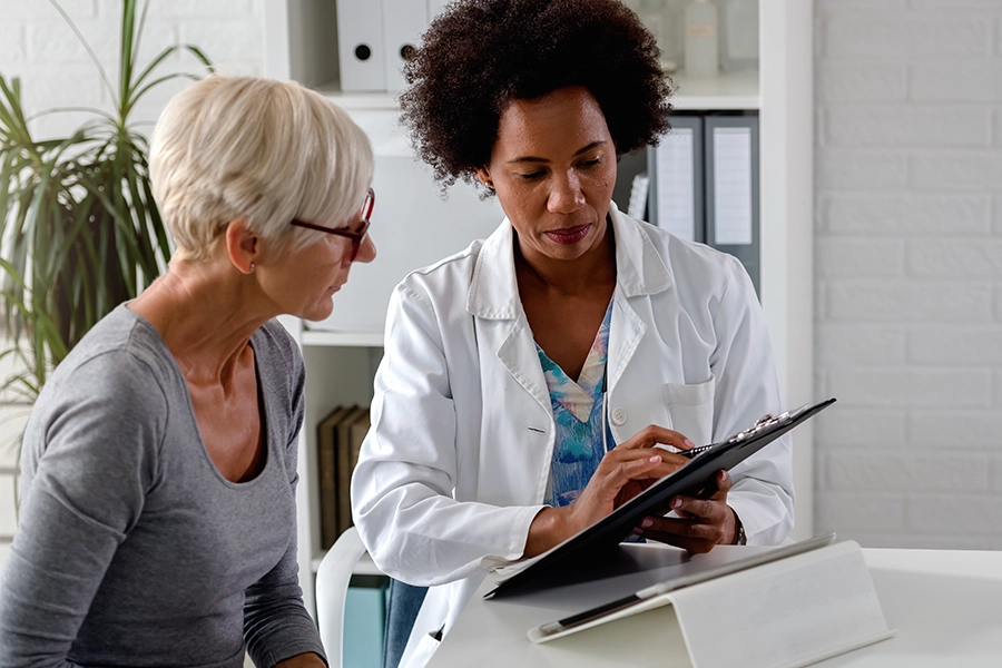 black female doctor with older female patient