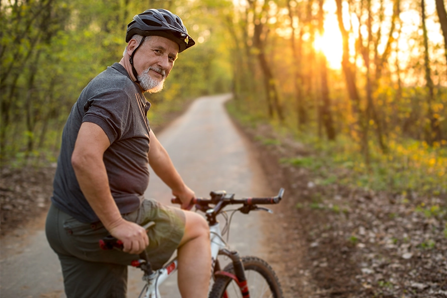 older man on bike has stopped and turned to look back